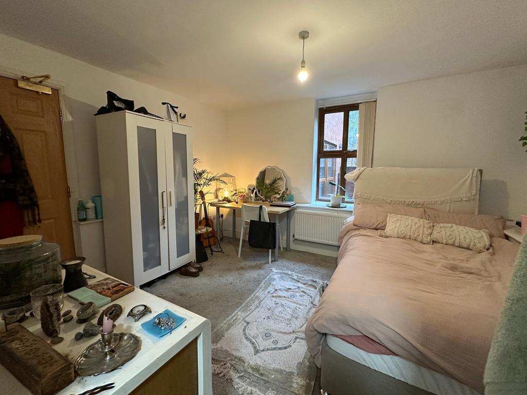 A cozy double bedroom featuring ample natural l...