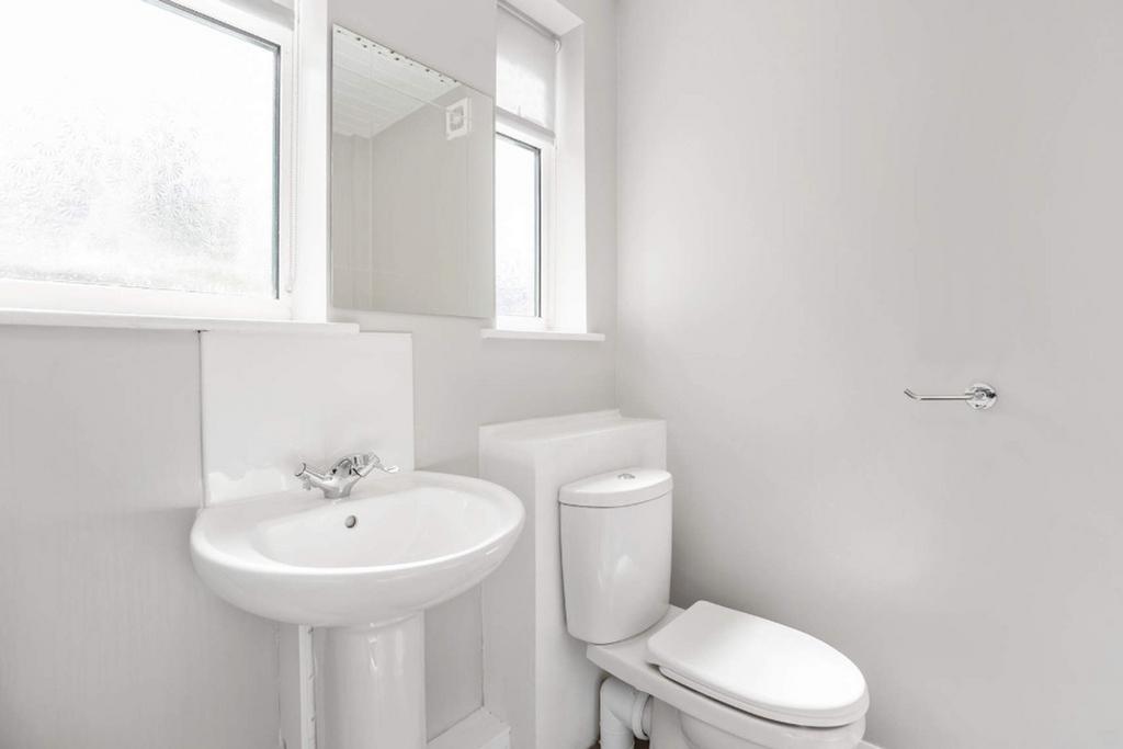 A bright and modern bathroom featuring a sleek ...