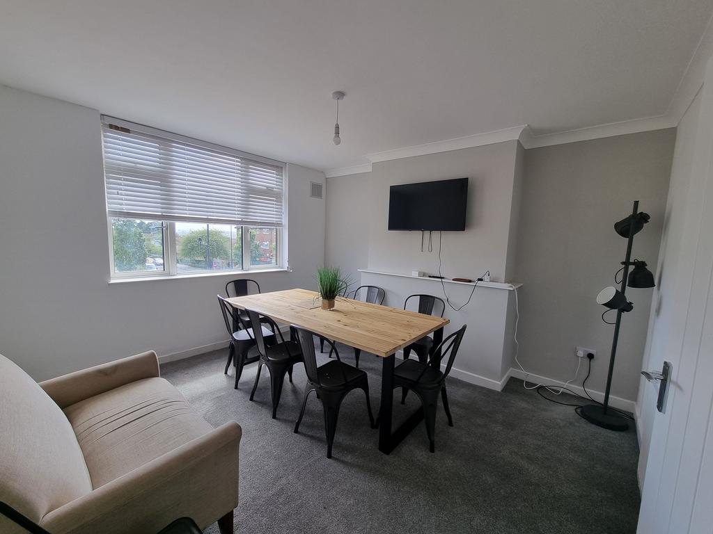 A spacious and well-lit modern living room with...