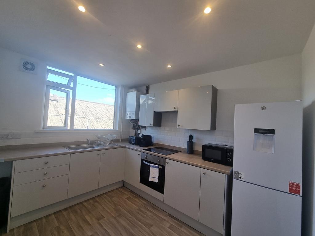A modern and bright kitchen with ample counter ...
