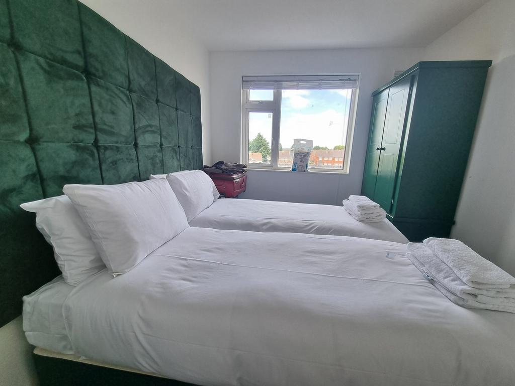 A clean and well-lit double bedroom with two be...