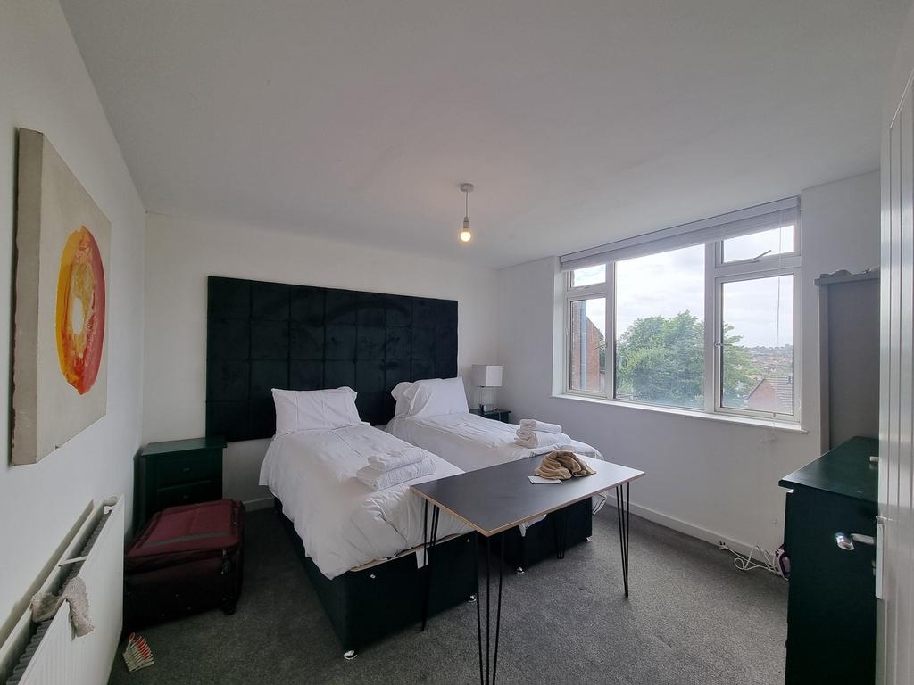 A bright and tidy double bedroom featuring two ...