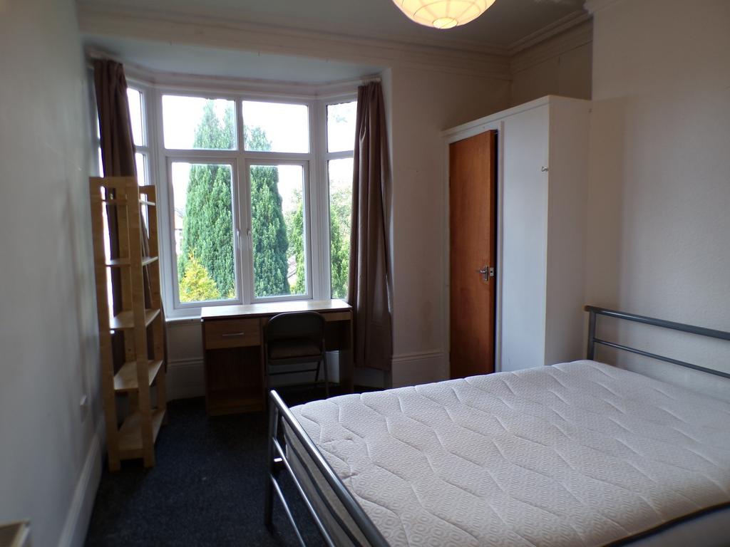 A bright and spacious double bedroom featuring ...
