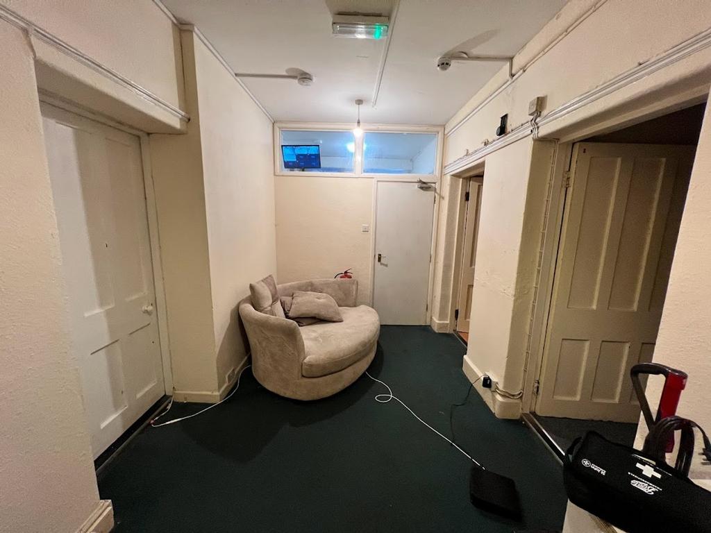 A spacious hallway area with potential for pers...