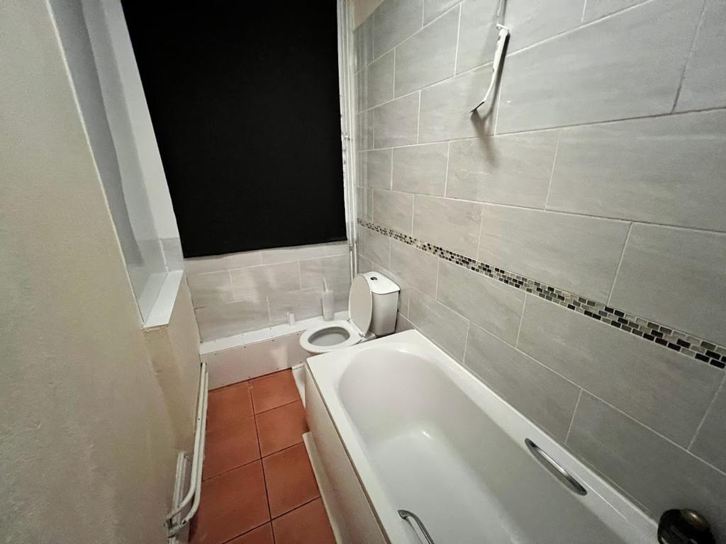 A tidy bathroom featuring a bath, perfect for r...