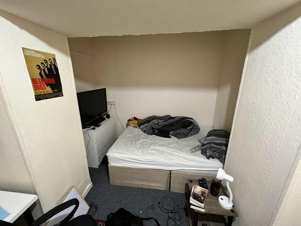 A cozy double bedroom with a comfortable bed an...