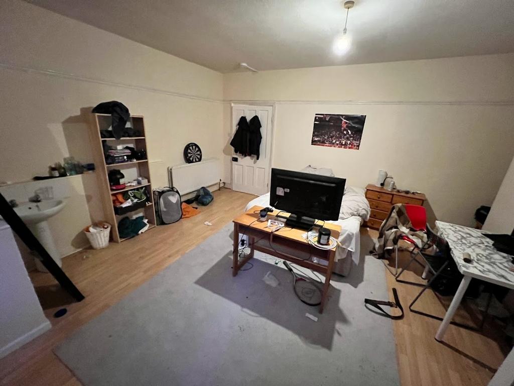 A spacious living room that offers a cozy atmos...