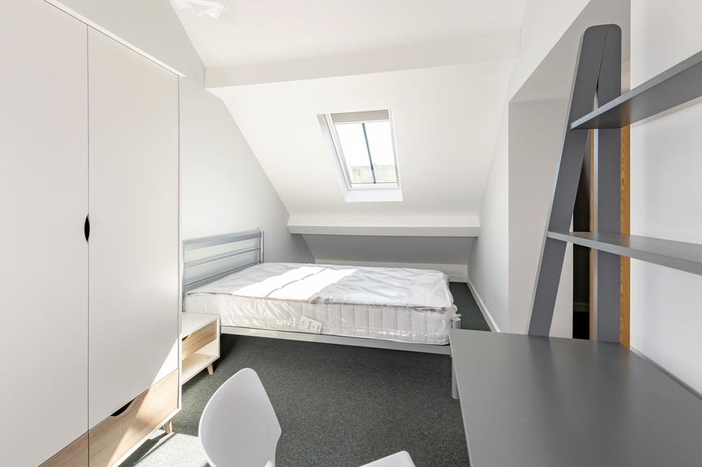 Bright and spacious double bedroom featuring a ...