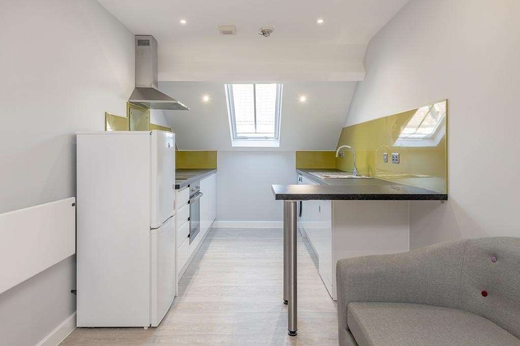 Modern kitchen featuring sleek cabinetry, ample...