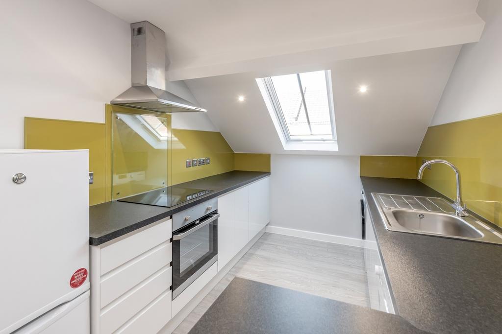 Bright and modern kitchen featuring sleek cabin...