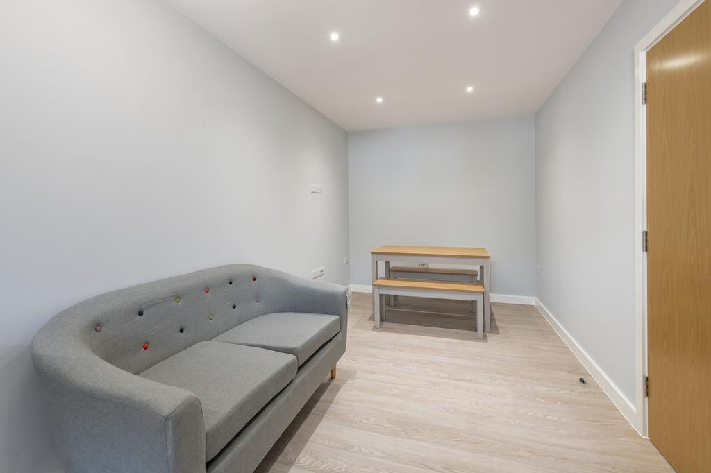 A bright and inviting communal workspace featur...