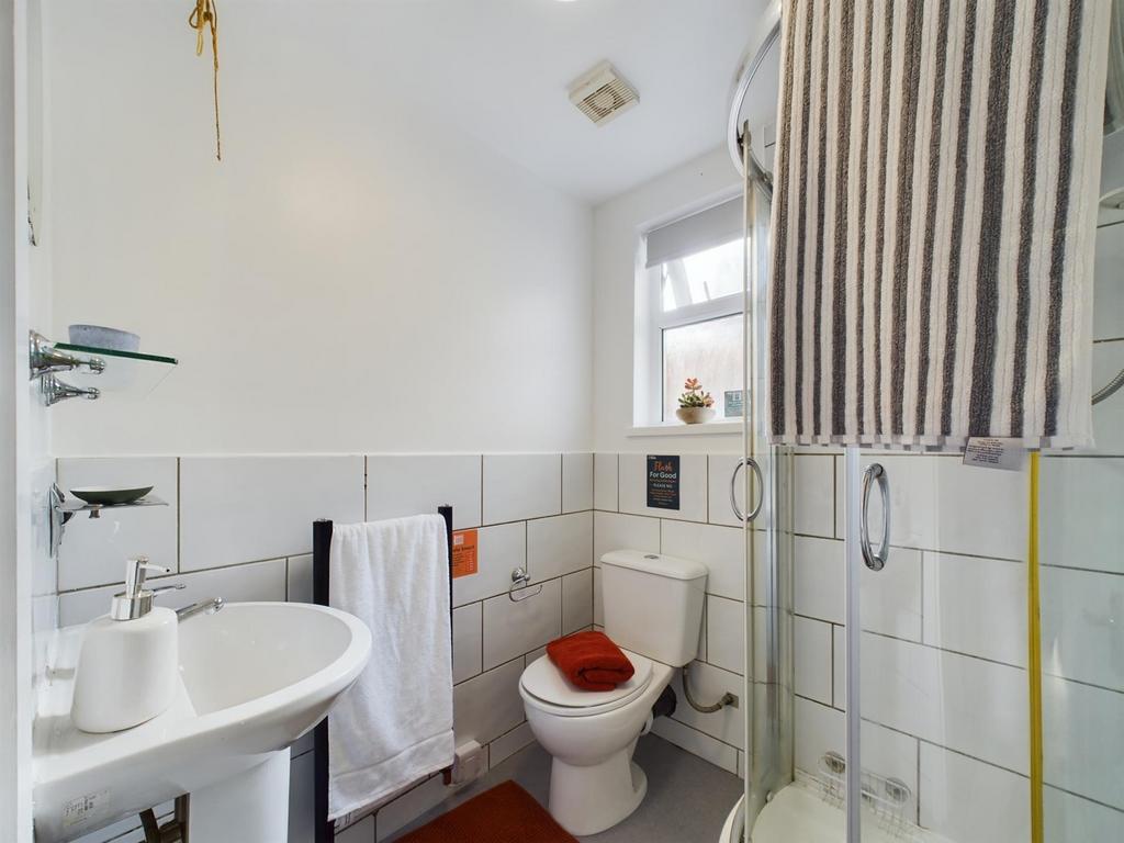 A bright and modern bathroom featuring a shower...
