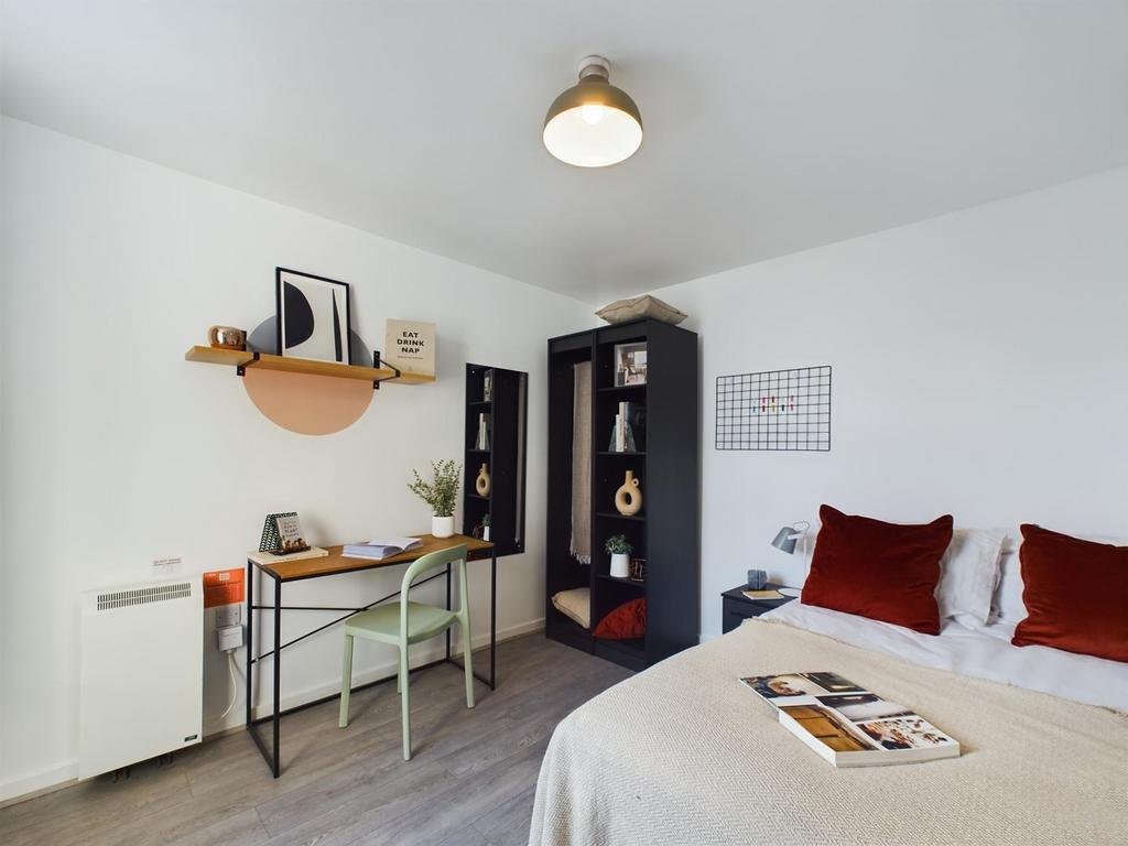 A bright and inviting double bedroom featuring ...