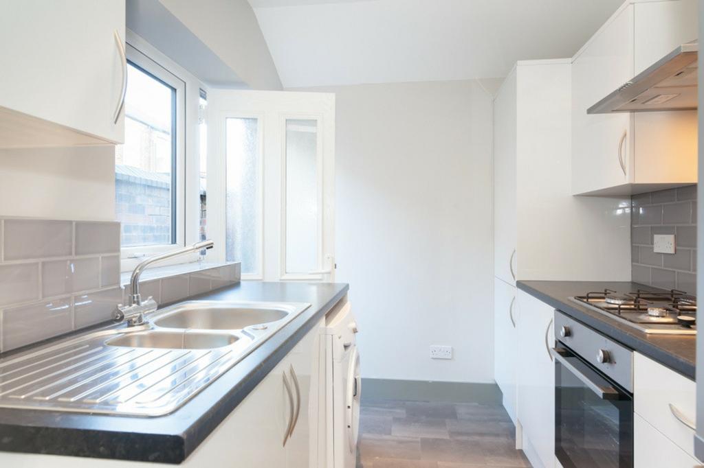 A bright and clean kitchenette with modern appl...