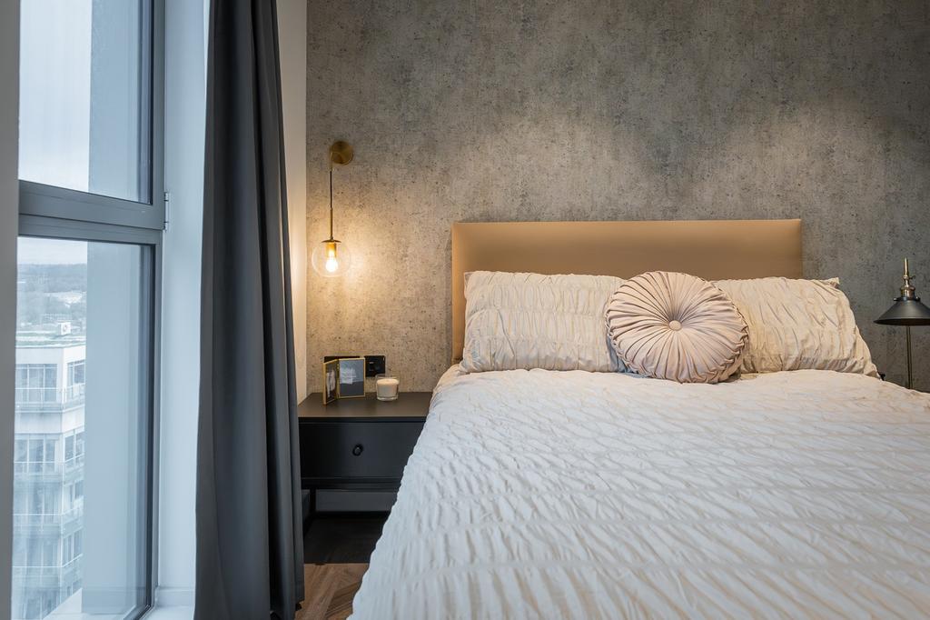 A stylish and well-lit double bedroom with mode...