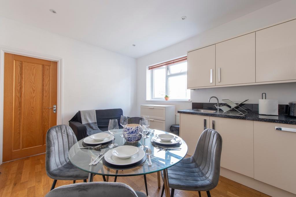 A bright and modern kitchenette with a stylish ...