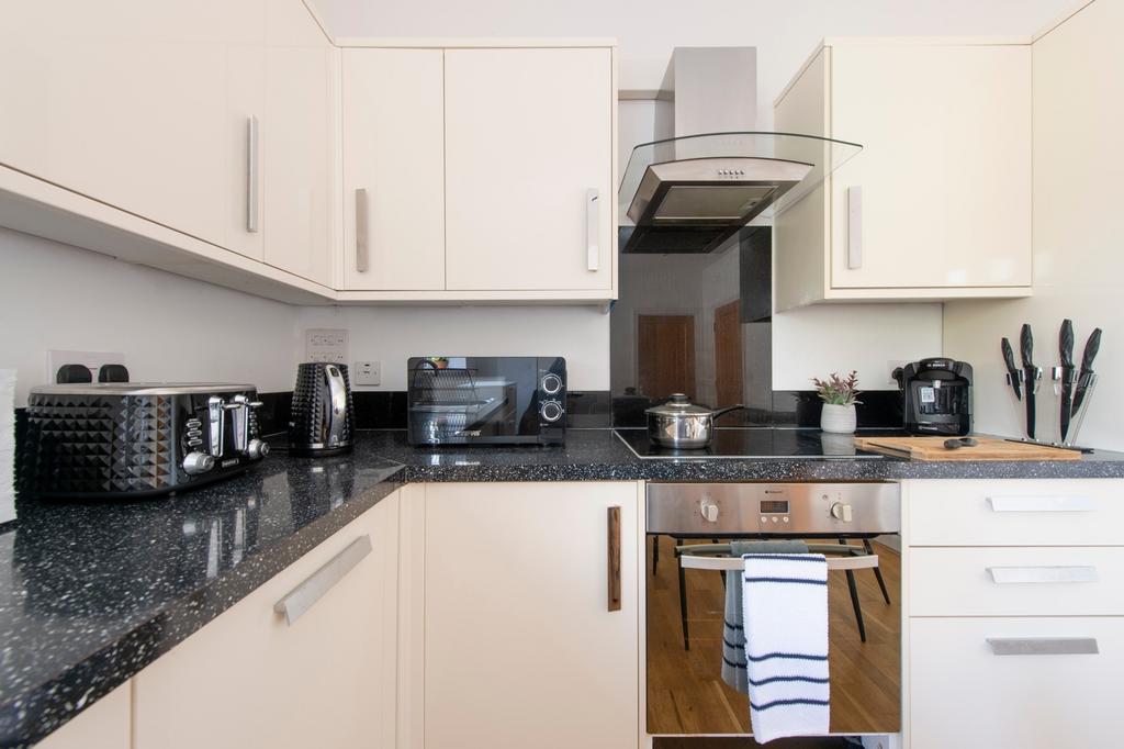 A modern and clean kitchenette equipped with st...