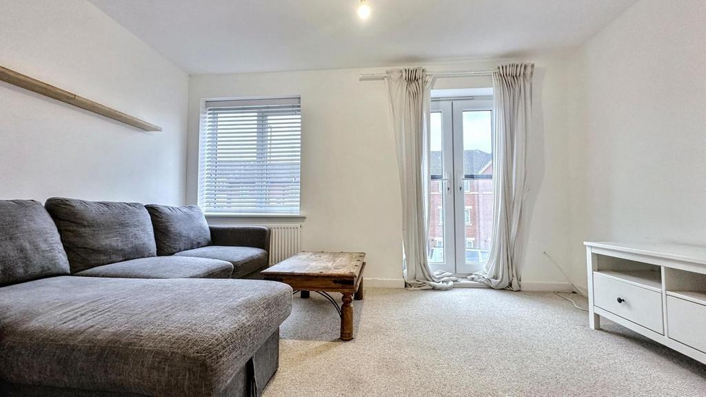 A spacious and inviting modern living room, per...