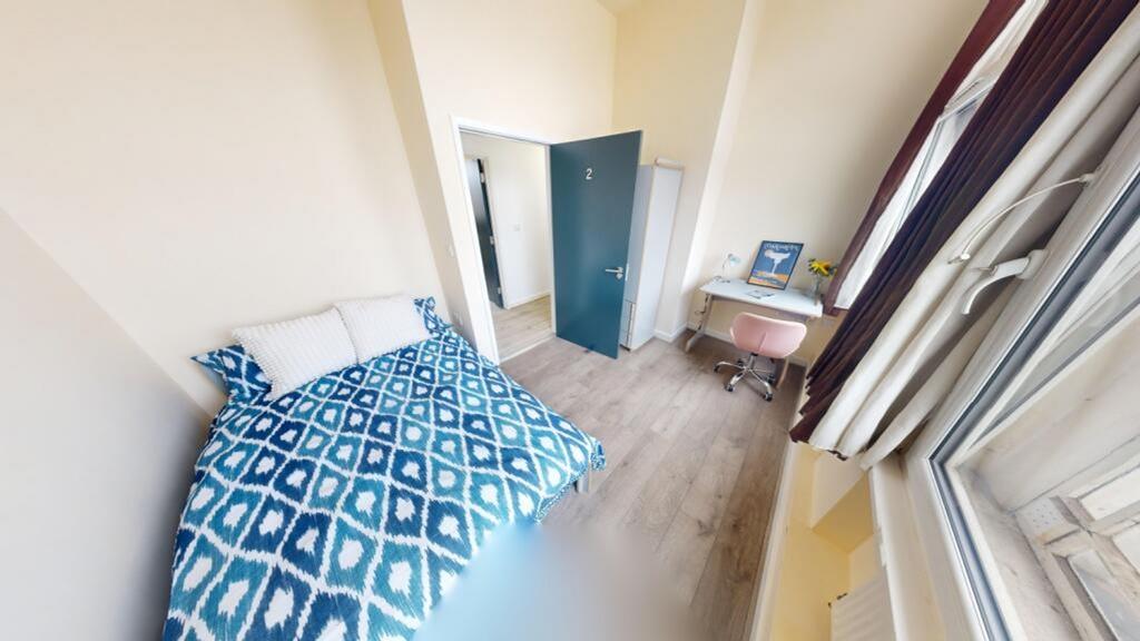 A bright and inviting double bedroom featuring ...