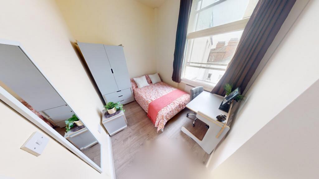 A bright and inviting double bedroom with moder...
