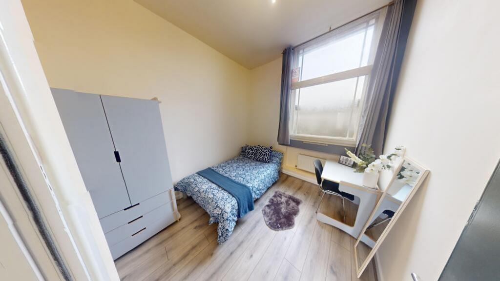 A well-lit and inviting double bedroom, perfect...