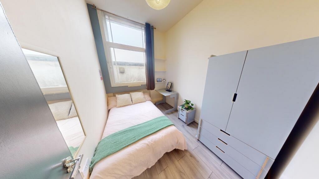 A bright and tidy double bedroom featuring ampl...
