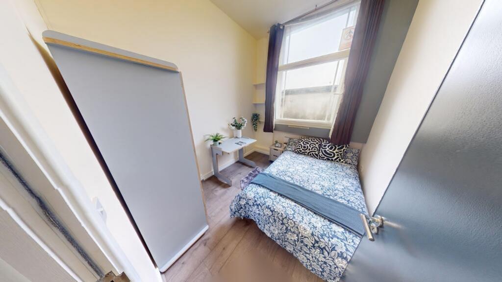A cozy and well-lit double bedroom, perfect for...