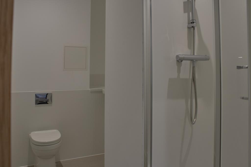A modern and tidy bathroom featuring a spacious...