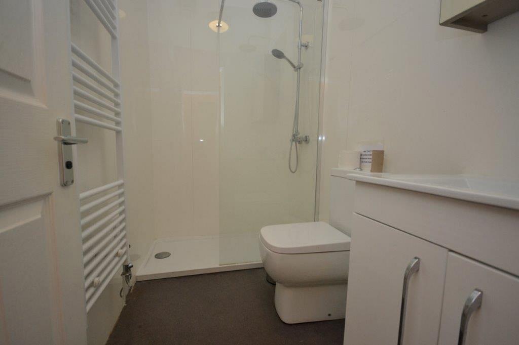 A clean and modern bathroom featuring a shower ...