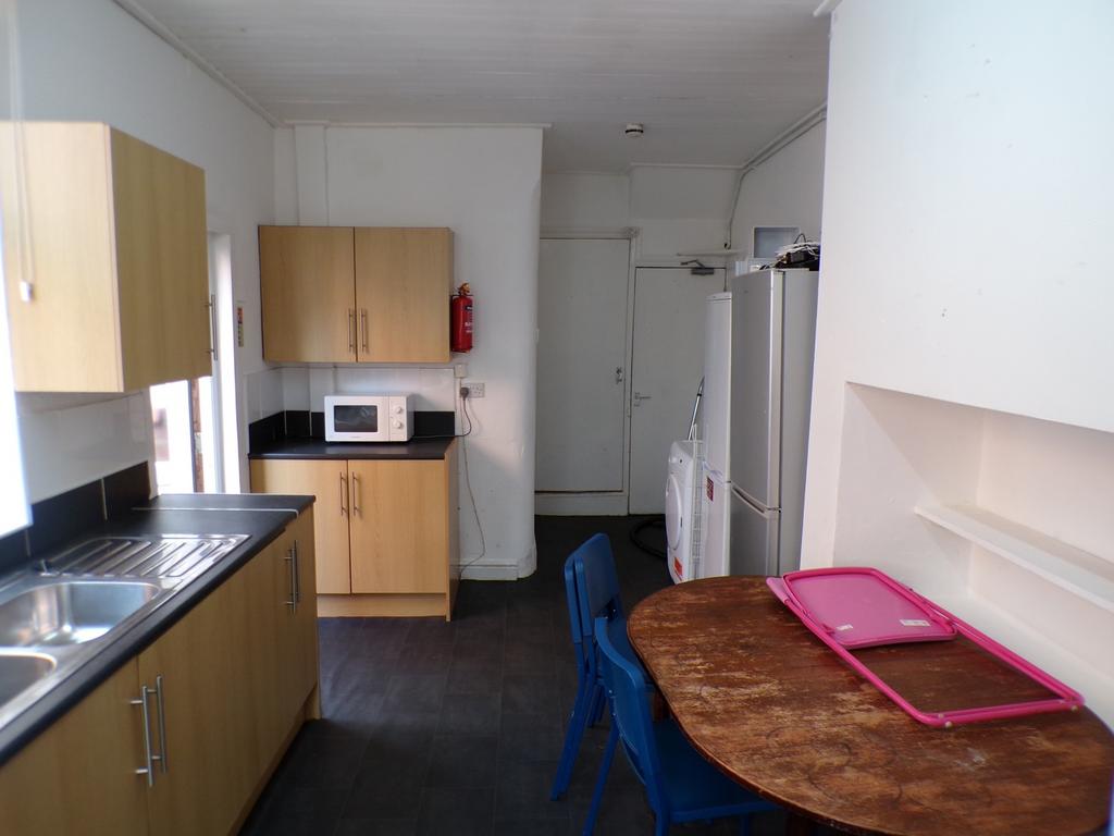 A functional and bright kitchenette with modern...