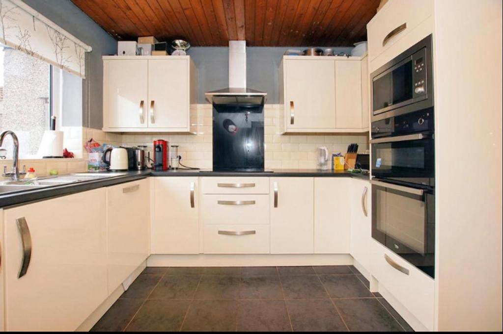 A modern and tidy kitchen with ample storage an...