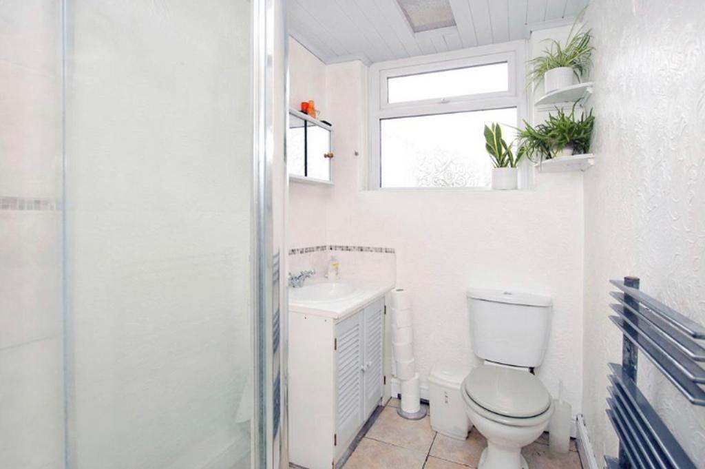 A bright and tidy bathroom featuring a shower a...