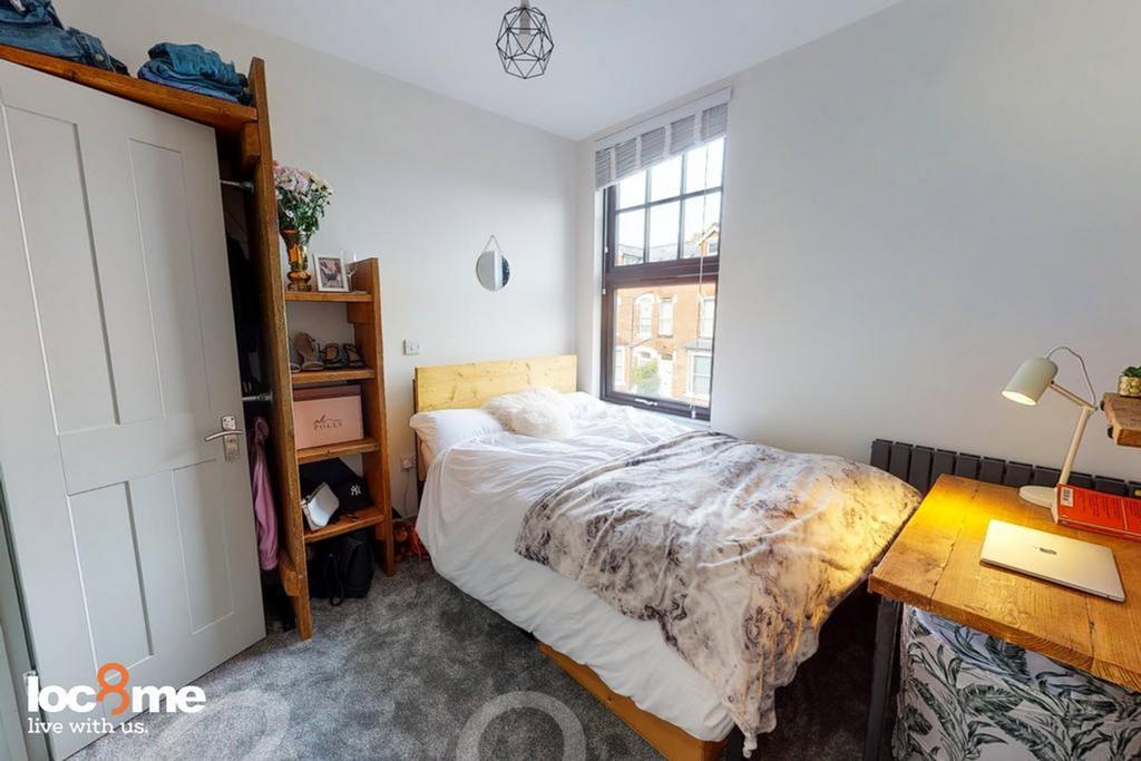 A bright and cozy double bedroom featuring styl...