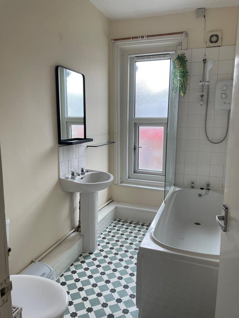 Bright and functional bathroom featuring a bath...