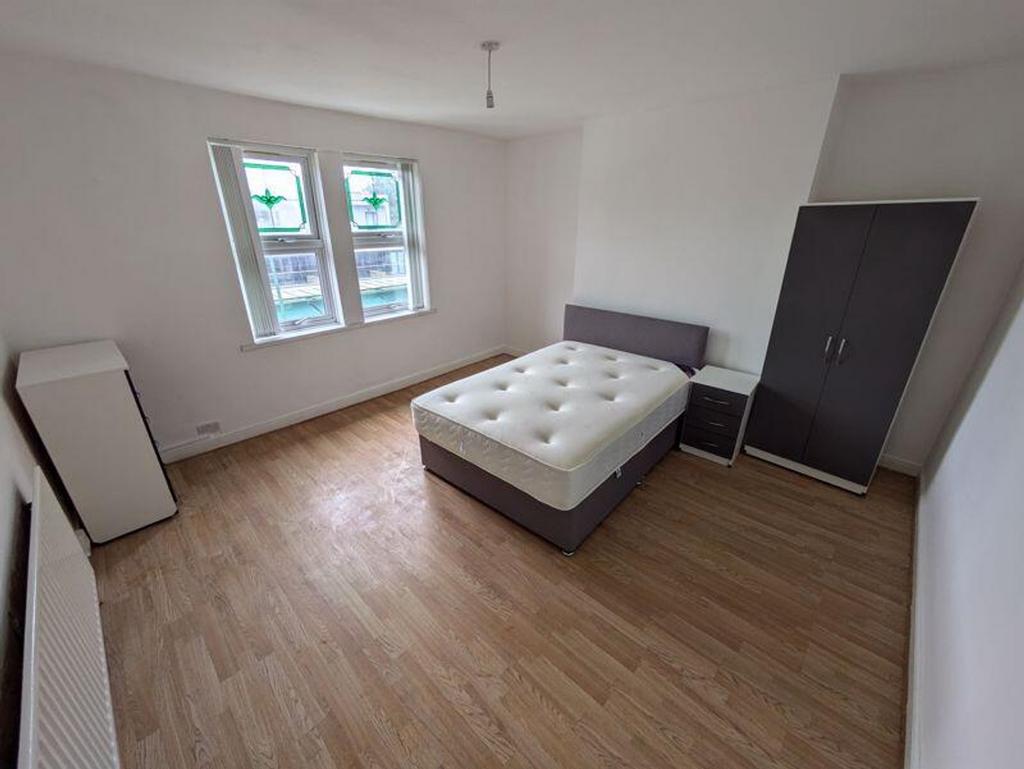 A spacious and bright double bedroom featuring ...