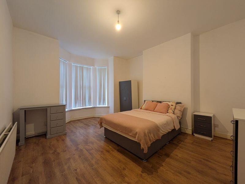 Bright, well-presented bedroom with a bay windo...