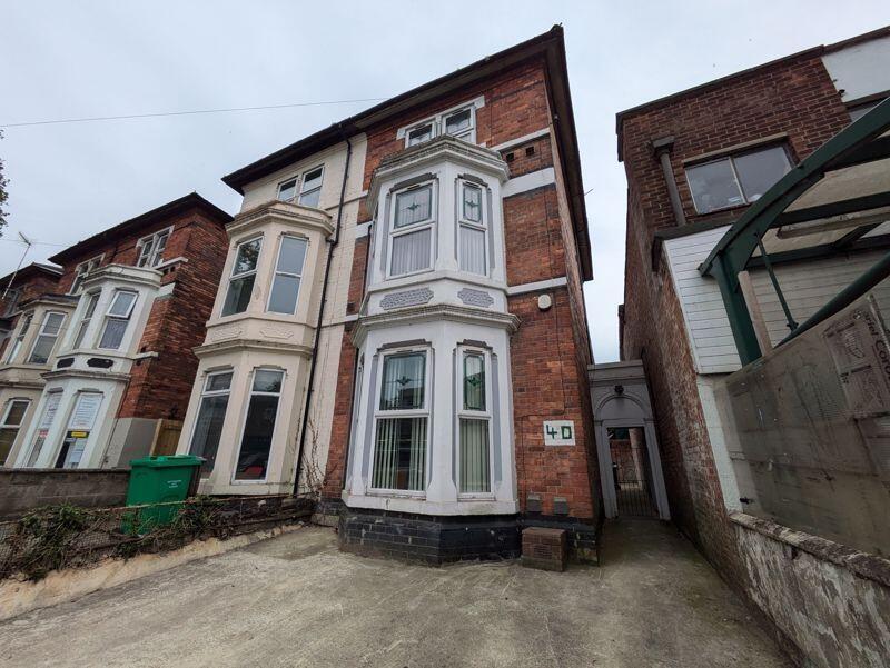 Victorian-style terraced house with bay windows...