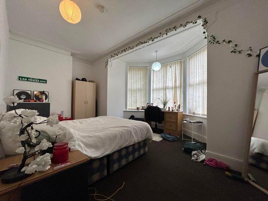 A spacious and bright double bedroom featuring ...