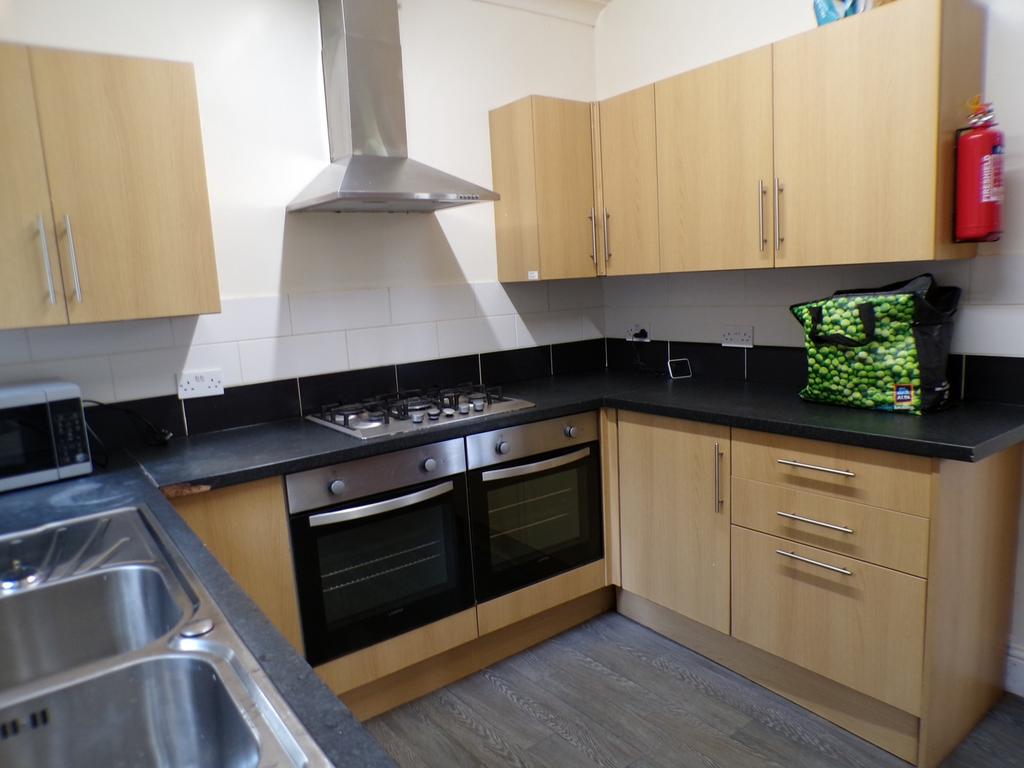 A functional and tidy kitchen with modern appli...