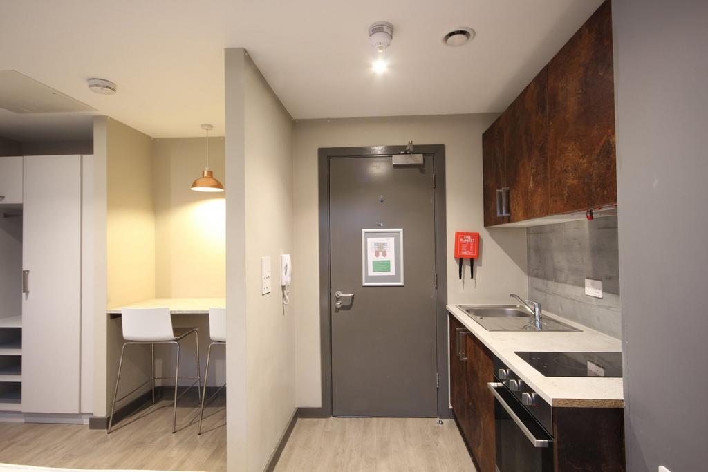 A modern kitchenette with sleek finishes and am...