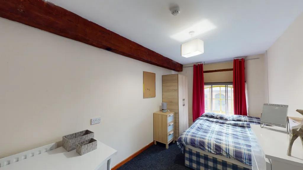 A bright and inviting double bedroom with moder...