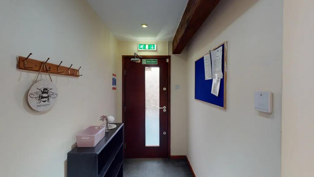 A tidy and inviting hallway with ample natural ...