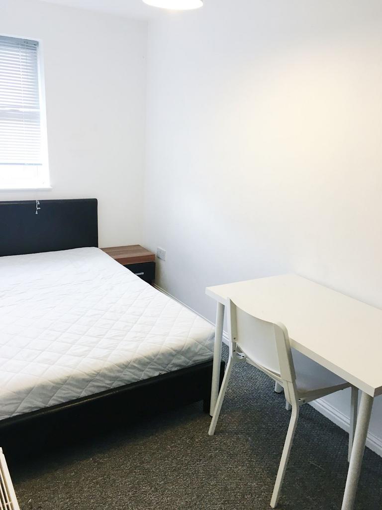 Bright, simply furnished double bedroom with a ...
