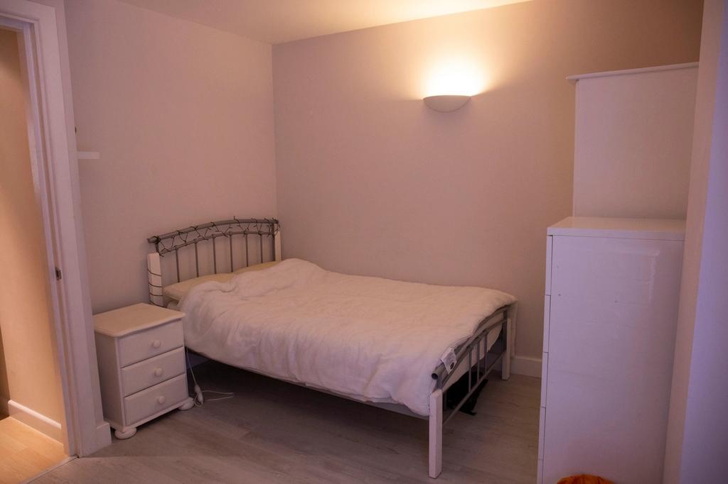 Cozy double bedroom featuring a comfortable bed...