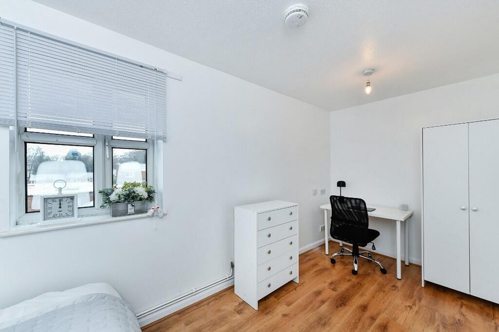 A bright and inviting double bedroom featuring ...
