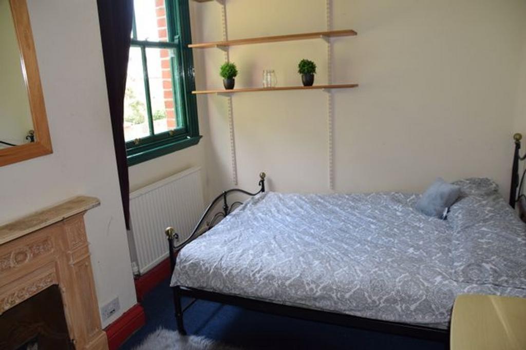 A charming double bedroom with good natural lig...