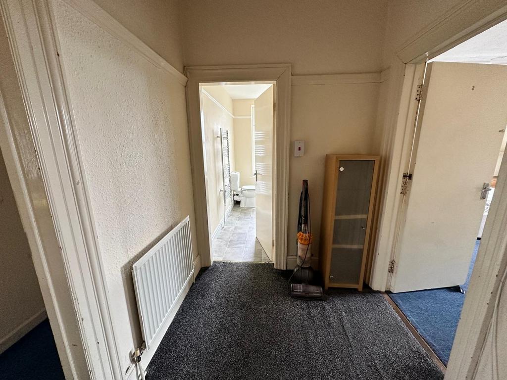Bright entrance hallway with new-looking neutra...