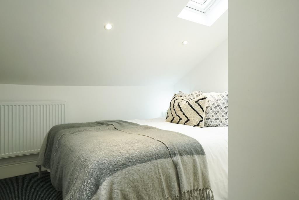 A clean and inviting double bedroom with cozy d...
