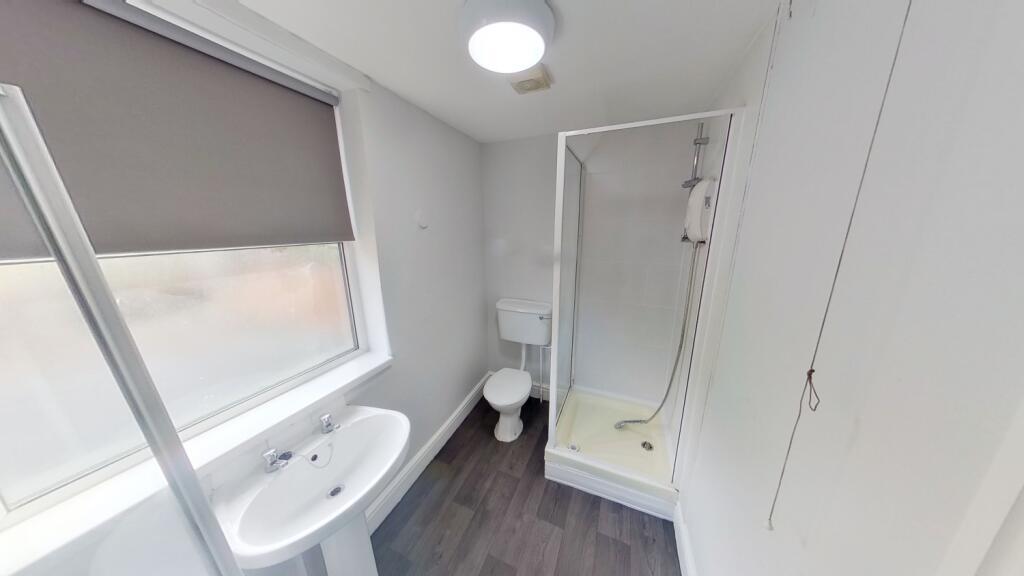 Bright and clean bathroom featuring a modern sh...