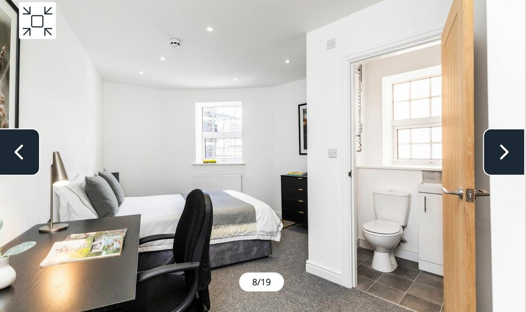 A spacious and inviting double bedroom with mod...